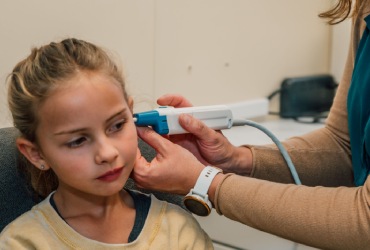 Audiologist testing hearing of child image