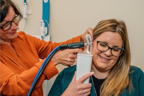 A patient receiving an ear cleaning