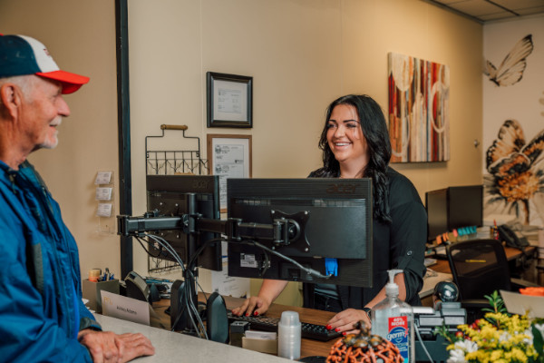 The front desk staff at Comprehensive Hearing Services welcoming a patient